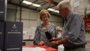 Adrian and Janette showing wine